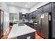 Updated kitchen features blue cabinets, stainless steel appliances, and a large island at 12551 Alcovy Rd, Covington, GA 30014