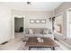 Comfortable living room featuring a cozy sofa, stylish rug, and natural light from the windows at 12551 Alcovy Rd, Covington, GA 30014