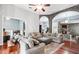 Spacious living room featuring stone arches, fireplace, hardwood floors and lots of seating at 12551 Alcovy Rd, Covington, GA 30014