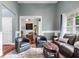 Inviting sitting room with hardwood floors, a sofa, and lots of natural light at 12551 Alcovy Rd, Covington, GA 30014