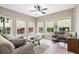 Bright sunroom with multiple windows and neutral tile floors at 12551 Alcovy Rd, Covington, GA 30014