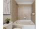 Cozy bathroom showcasing tiled walls and a bathtub with a shower, alongside an elegant framed picture at 3324 Peachtree Ne Rd # 2808, Atlanta, GA 30326