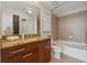 Bathroom with granite counters, wood cabinets, and tiled shower and bath at 3324 Peachtree Ne Rd # 2808, Atlanta, GA 30326