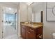 Bathroom with modern fixtures, granite counters, wood cabinets, and a door to a balcony with city views at 3324 Peachtree Ne Rd # 2808, Atlanta, GA 30326