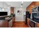 Well-equipped kitchen with wooden cabinets, stainless steel appliances, and stylish black backsplash at 3324 Peachtree Ne Rd # 2808, Atlanta, GA 30326