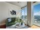 Cozy living room with a green sofa, stylish decor, and a large window offering city views at 3324 Peachtree Ne Rd # 2808, Atlanta, GA 30326
