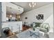 Open-concept living room with hardwood floors, modern lighting, and a comfortable green sofa at 3324 Peachtree Ne Rd # 2808, Atlanta, GA 30326