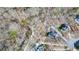 Aerial view of property showcasing wooded surroundings and multiple structures at 416 Delane Dr, Dallas, GA 30157