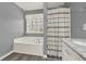 Neutral bathroom with a marble countertop vanity, a tub and shower combination with a patterned shower curtain at 416 Delane Dr, Dallas, GA 30157