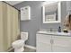 Neutral bathroom with a vanity with a granite countertop, a mirror, and a shower with tan curtain at 416 Delane Dr, Dallas, GA 30157