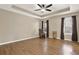 Spacious primary bedroom featuring hardwood floors, a tray ceiling, and lots of natural light at 416 Delane Dr, Dallas, GA 30157