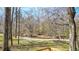 Backyard with a creek, small beach and firepit provides a peaceful retreat at 416 Delane Dr, Dallas, GA 30157