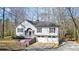 Charming home featuring a 2-car garage, stone accents, flowering plants, and lovely front yard at 416 Delane Dr, Dallas, GA 30157