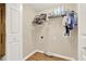 Small laundry room with hardwood floors and white walls and door at 416 Delane Dr, Dallas, GA 30157