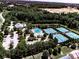 Aerial view showcases a community amenity center with a pool, tennis courts, and clubhouse at 134 Edinburgh Dr, Canton, GA 30115