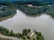 A serene aerial view of a lake, highlighting a small building near the shoreline at 134 Edinburgh Dr, Canton, GA 30115