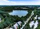 Aerial view shows the community lake with surrounding trees and a walking trail nearby at 134 Edinburgh Dr, Canton, GA 30115