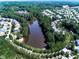 A lovely aerial view shows the lake as the centerpiece of the community at 134 Edinburgh Dr, Canton, GA 30115