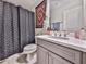 Bathroom featuring gray vanity with white sink, decorative mirror, and patterned shower curtain at 134 Edinburgh Dr, Canton, GA 30115