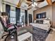 Bedroom with wooden ceiling beams, home office setup, and daybed underneath a wall-mounted TV at 134 Edinburgh Dr, Canton, GA 30115