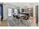 Dining area featuring a modern table with seating for six, with kitchen view and access to patio at 134 Edinburgh Dr, Canton, GA 30115