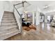Inviting entryway with hardwood floors, staircase, and an open floor plan leading into the living area at 134 Edinburgh Dr, Canton, GA 30115