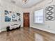 Bright entryway featuring wood-look tile flooring, a decorative mirror, and a rustic wooden front door at 134 Edinburgh Dr, Canton, GA 30115