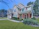 Beautiful two-story home with stone and brick accents, a covered porch, and a well-maintained front yard at 134 Edinburgh Dr, Canton, GA 30115