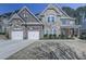 Two-story home boasting stone and brick accents, complemented by a manicured lawn and driveway at 134 Edinburgh Dr, Canton, GA 30115