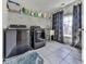 Laundry room features modern washer and dryer, a utility sink, and ample shelving at 134 Edinburgh Dr, Canton, GA 30115