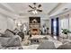 Spacious living room with a stone fireplace, large sectional sofa, and coffered ceilings with a ceiling fan at 134 Edinburgh Dr, Canton, GA 30115