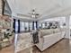 Bright living room featuring a stone fireplace, ceiling fan and large windows with natural light at 134 Edinburgh Dr, Canton, GA 30115