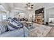 Inviting living room with a stone fireplace, plush sofa, and hardwood floors covered with a large area rug at 134 Edinburgh Dr, Canton, GA 30115