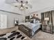 Cozy main bedroom with a ceiling fan, tray ceilings, and neutral carpet at 134 Edinburgh Dr, Canton, GA 30115
