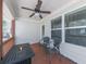 Cozy covered patio with ceiling fan, seating, and table with integrated fire pit at 134 Edinburgh Dr, Canton, GA 30115