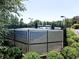 Fenced tennis courts are surrounded by manicured landscaping at 134 Edinburgh Dr, Canton, GA 30115