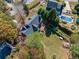 Aerial view of home with mature trees, lush landscaping, and an in-ground pool in the backyard at 210 Timber Laurel Ct, Lawrenceville, GA 30043