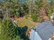 Aerial view of a blue house with a large backyard, surrounded by mature trees and greenery at 210 Timber Laurel Ct, Lawrenceville, GA 30043
