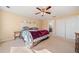 Serene bedroom featuring a ceiling fan, closet, and doorway leading to the bathroom at 210 Timber Laurel Ct, Lawrenceville, GA 30043