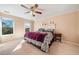 Cozy bedroom with a ceiling fan, two windows offering natural light and a comfortable king-size bed at 210 Timber Laurel Ct, Lawrenceville, GA 30043