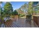 A well kept wooden deck with outdoor seating and a view of the spacious backyard at 210 Timber Laurel Ct, Lawrenceville, GA 30043