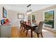 Dining room featuring a chandelier and a view of the wooded outdoors at 210 Timber Laurel Ct, Lawrenceville, GA 30043