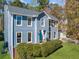 Charming two-story home with blue siding, a manicured lawn and neatly trimmed shrubbery at 210 Timber Laurel Ct, Lawrenceville, GA 30043