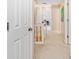 Carpeted hallway featuring linen closet, neutral paint, and natural light at 210 Timber Laurel Ct, Lawrenceville, GA 30043