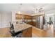 Granite countertops and stainless appliances are highlighted in this spacious kitchen with a ceiling fan at 210 Timber Laurel Ct, Lawrenceville, GA 30043