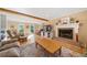 Inviting living room with a brick fireplace and a comfortable seating area with lots of natural light at 210 Timber Laurel Ct, Lawrenceville, GA 30043