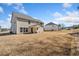 Expansive backyard view of a two-story home with a covered patio and ample space at 3505 Aqua Point Pl, Cumming, GA 30041