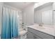 Bathroom featuring a shower-tub combo with a blue-ombre shower curtain and a gray vanity at 3505 Aqua Point Pl, Cumming, GA 30041