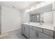 This bathroom has a double vanity with gray cabinets, granite countertops, and a large mirror at 3505 Aqua Point Pl, Cumming, GA 30041