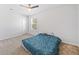 This bedroom has a window for natural light, a ceiling fan and neutral carpet at 3505 Aqua Point Pl, Cumming, GA 30041